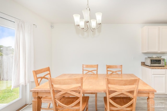 dining room with a notable chandelier and a toaster