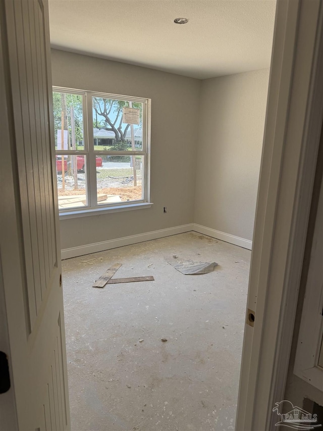 empty room featuring baseboards