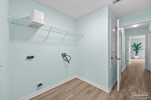 laundry room with hardwood / wood-style flooring and hookup for a washing machine