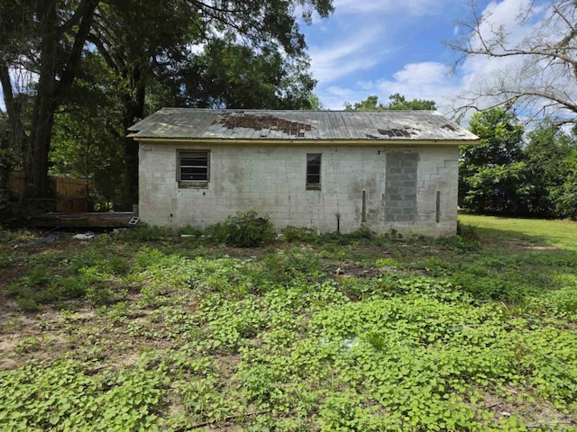 420 Forrest St, Cantonment, FL 32533 - view of property exterior featuring a metal roof and concrete block siding