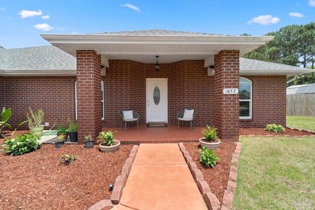 1052 Ashley Rd, Milton, FL 32583 - entrance to property with a shingled roof, brick siding, a patio, and fence