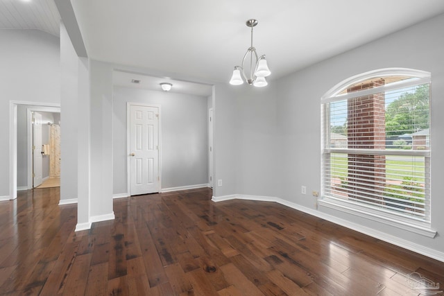 1052 Ashley Rd, Milton, FL 32583 - spare room featuring dark wood-type flooring, a chandelier, baseboards, and lofted ceiling
