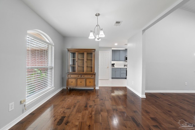 1052 Ashley Rd, Milton, FL 32583 - dining space with a chandelier, dark wood-style flooring, and baseboards
