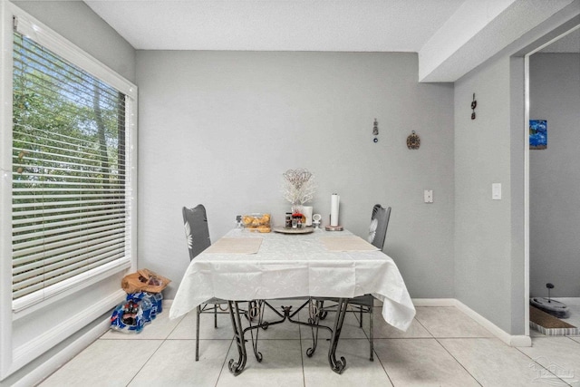 dining area with light tile patterned floors