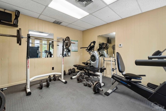 exercise room featuring a paneled ceiling