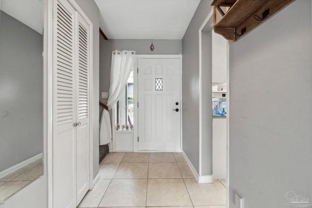 entrance foyer featuring a textured ceiling and light tile patterned floors