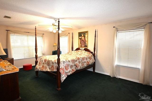 bedroom with ceiling fan, a textured ceiling, and carpet floors