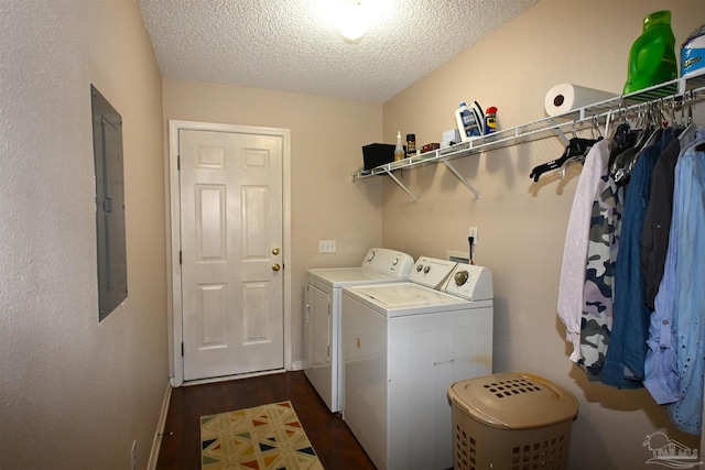 laundry area with dark wood-type flooring, electric panel, washing machine and dryer, and a textured ceiling