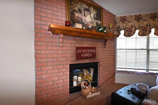 room details featuring a textured ceiling and a brick fireplace