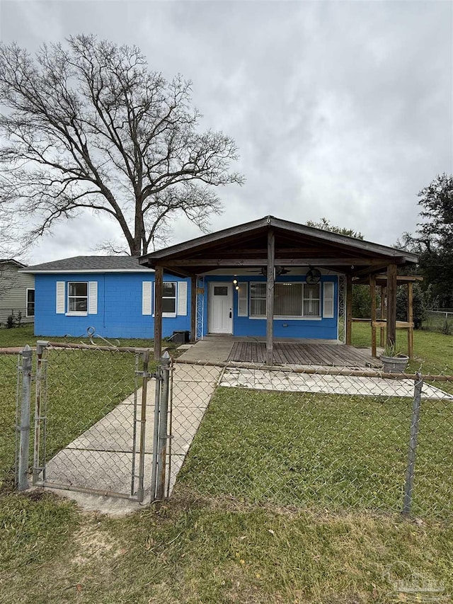 view of front facade with a fenced front yard, a front lawn, and a gate