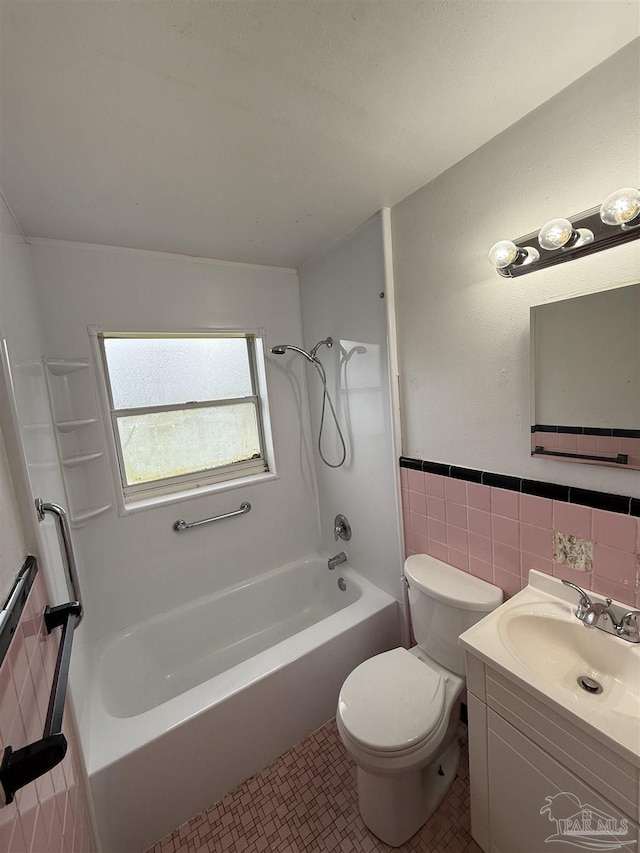 full bathroom featuring toilet, shower / tub combination, wainscoting, tile patterned floors, and tile walls