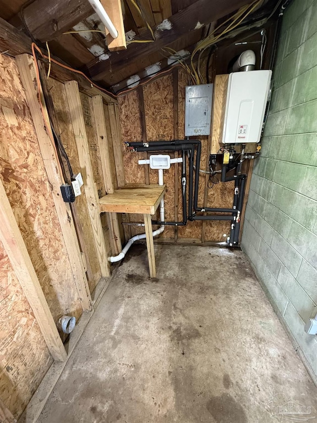 below grade area featuring electric panel, water heater, and concrete block wall