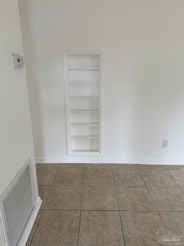 room details featuring built in shelves, baseboards, and visible vents