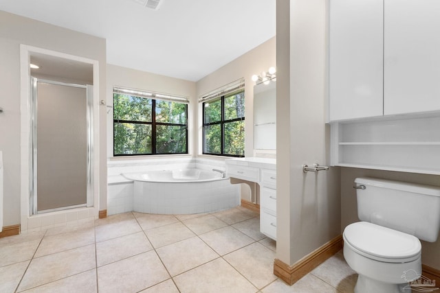 bathroom featuring tile patterned flooring, a shower stall, and toilet