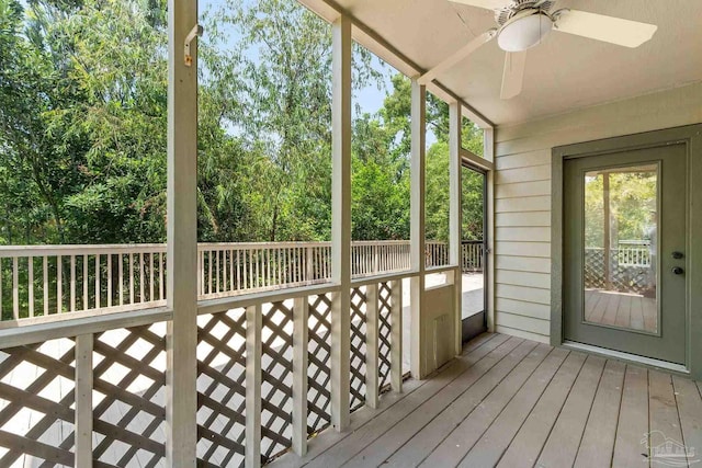 unfurnished sunroom featuring a ceiling fan