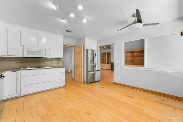 kitchen with white cabinetry, white appliances, visible vents, and ceiling fan