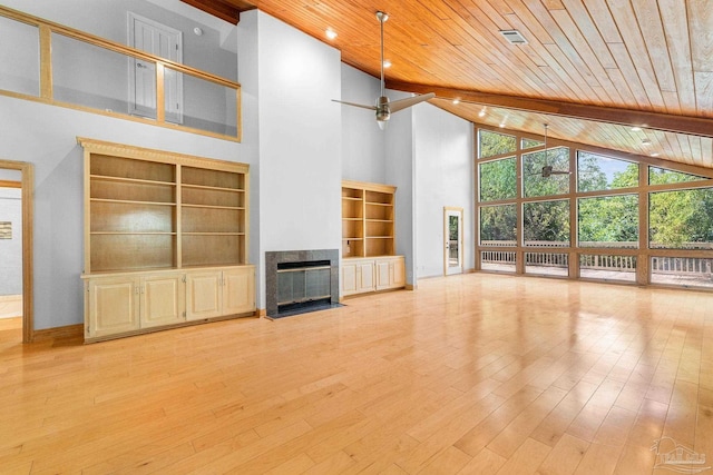 unfurnished living room featuring light wood-style flooring, wood ceiling, ceiling fan, and a tiled fireplace