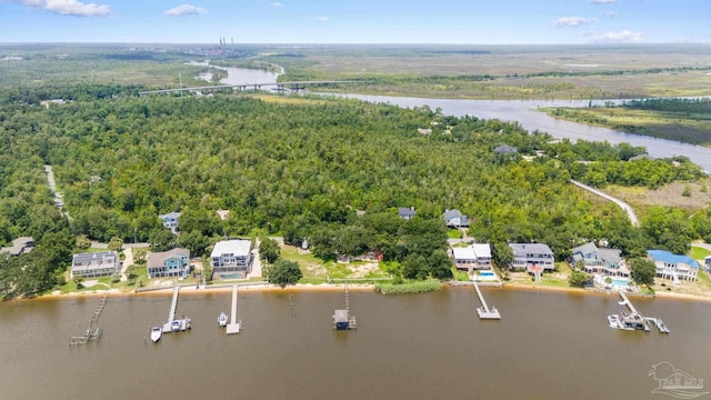 aerial view with a wooded view and a water view