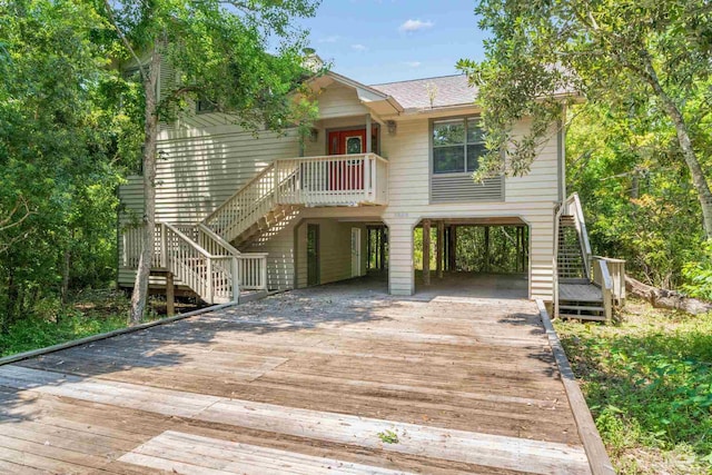 view of front of property with stairs, a carport, and driveway