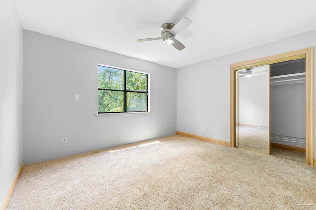 unfurnished bedroom featuring a ceiling fan, carpet, and a closet