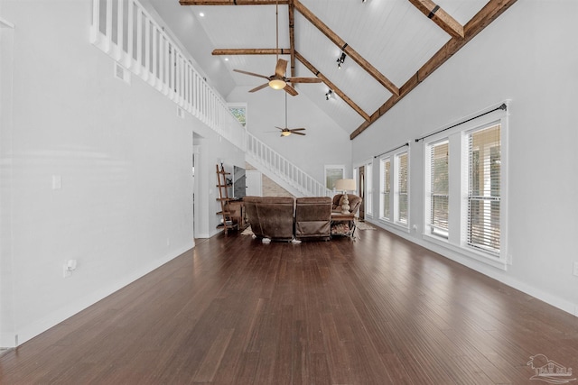 unfurnished living room featuring beam ceiling, a ceiling fan, high vaulted ceiling, and dark wood-style floors
