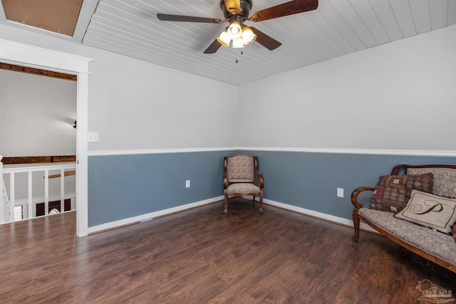 living area featuring a ceiling fan, wood ceiling, baseboards, and wood finished floors