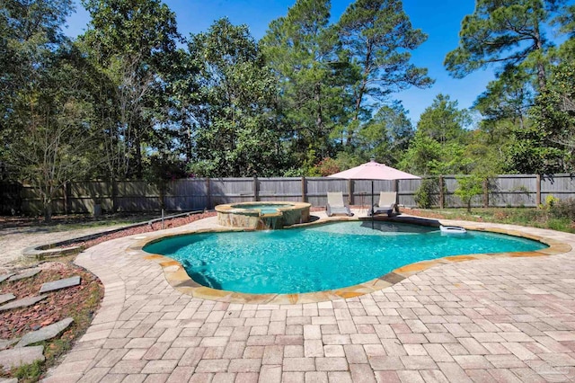 view of swimming pool with a fenced backyard, a pool with connected hot tub, and a patio
