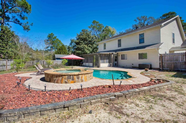 view of pool with a patio, a sunroom, and a fenced backyard