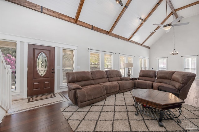 living area with high vaulted ceiling, plenty of natural light, and wood-type flooring