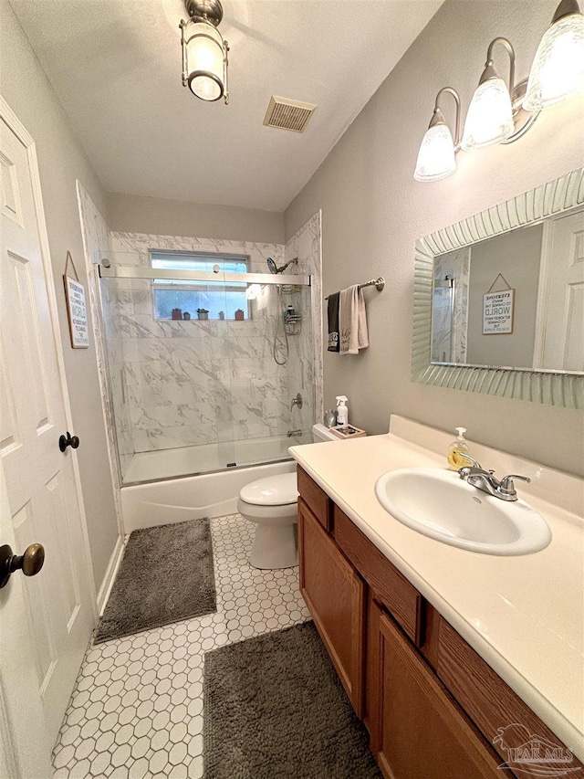 full bathroom featuring vanity, toilet, and combined bath / shower with glass door