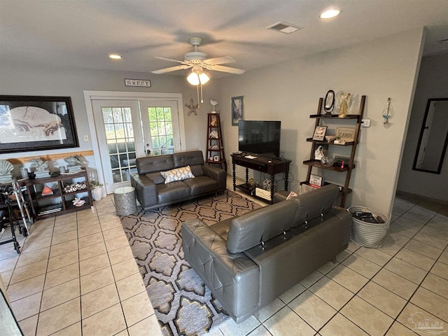 living room with ceiling fan, french doors, and light tile patterned floors