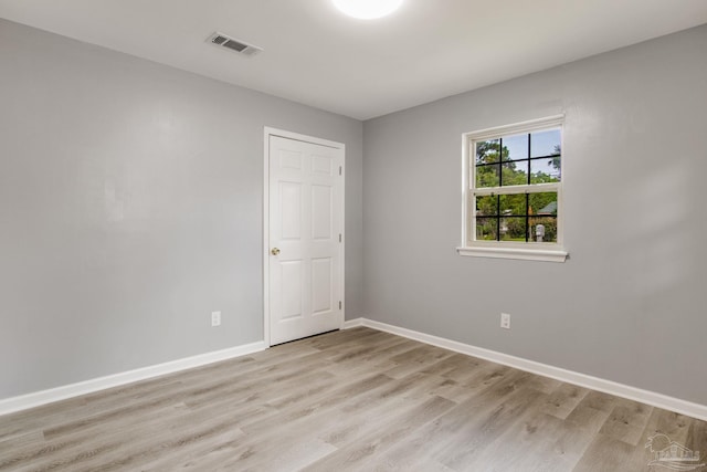 unfurnished room with light wood-type flooring