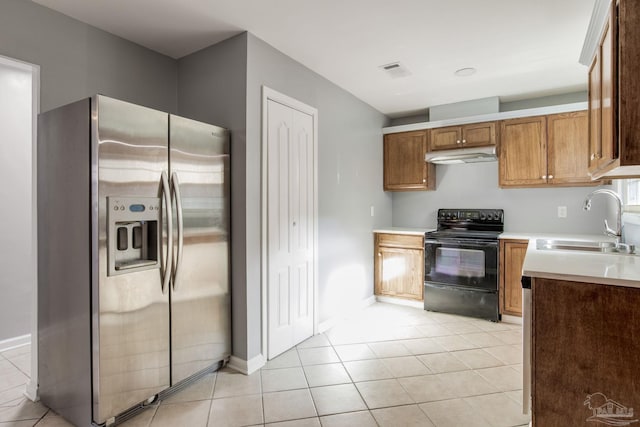 kitchen featuring black / electric stove, stainless steel fridge with ice dispenser, sink, and light tile patterned floors