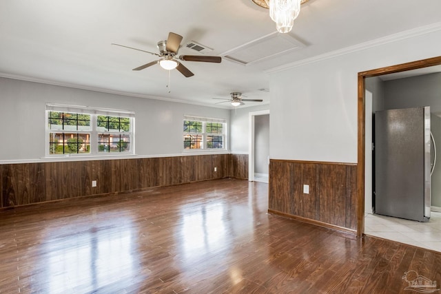 spare room with light hardwood / wood-style floors, crown molding, and ceiling fan