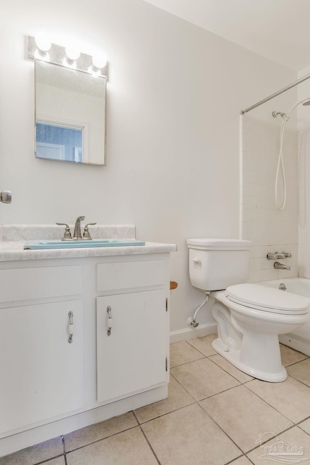 full bathroom with tile patterned flooring, tiled shower / bath, toilet, and vanity