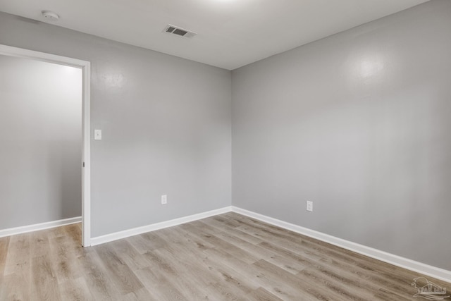 spare room featuring wood-type flooring