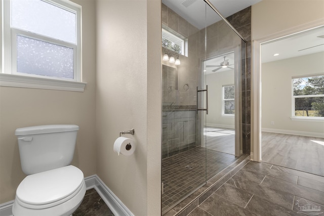 bathroom with toilet, walk in shower, ceiling fan, and plenty of natural light