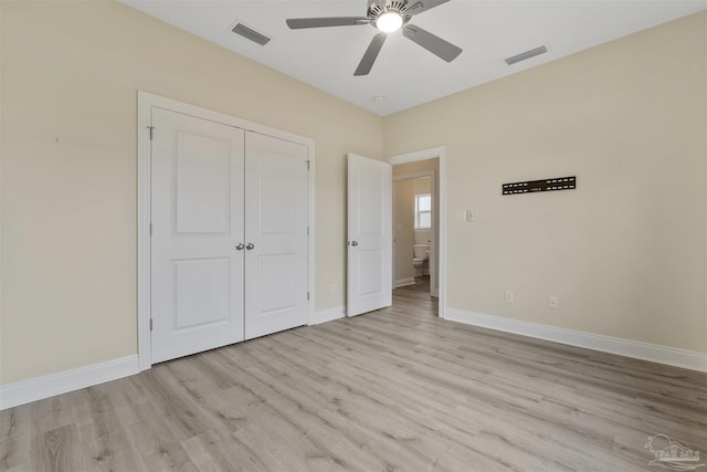 unfurnished bedroom with a closet, ceiling fan, and light wood-type flooring