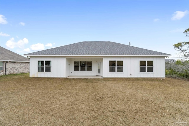 back of house featuring a lawn