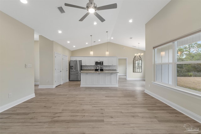 kitchen with a center island with sink, appliances with stainless steel finishes, hanging light fixtures, light hardwood / wood-style floors, and white cabinetry