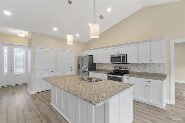 kitchen with sink, white cabinets, backsplash, and appliances with stainless steel finishes