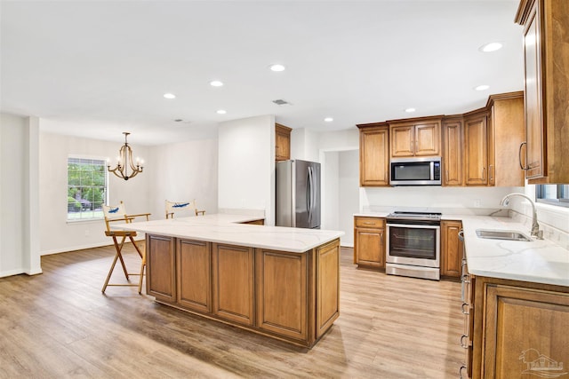 1118 Tall Pine Trl, Gulf Breeze, FL 32561 - kitchen featuring appliances with stainless steel finishes, a sink, light wood-type flooring, light stone countertops, and recessed lighting