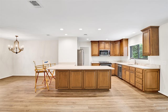 1118 Tall Pine Trl, Gulf Breeze, FL 32561 - kitchen featuring stainless steel appliances, light wood-type flooring, a sink, brown cabinets, and recessed lighting