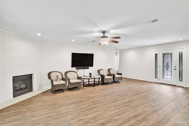 1118 Tall Pine Trl, Gulf Breeze, FL 32561 - sitting room featuring wood finished floors, a ceiling fan, recessed lighting, and a brick fireplace