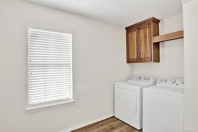 1118 Tall Pine Trl, Gulf Breeze, FL 32561 - laundry room featuring separate washer and dryer, cabinet space, wood finished floors, and baseboards