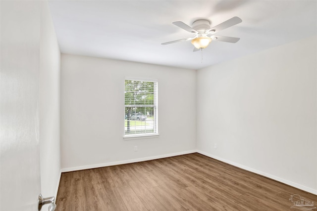 1118 Tall Pine Trl, Gulf Breeze, FL 32561 - empty room with wood finished floors, ceiling fan, and baseboards