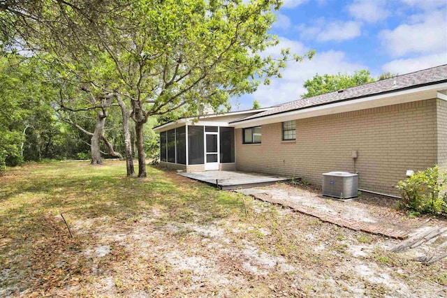 1118 Tall Pine Trl, Gulf Breeze, FL 32561 - rear view of house featuring a sunroom, cooling unit, brick siding, and a deck