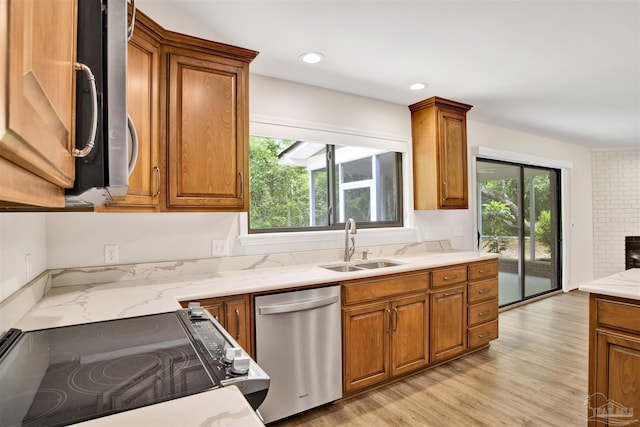 1118 Tall Pine Trl, Gulf Breeze, FL 32561 - kitchen with appliances with stainless steel finishes, a sink, brown cabinets, light stone counters, and recessed lighting