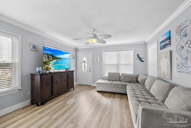 living room featuring light wood-type flooring, a wealth of natural light, and ceiling fan