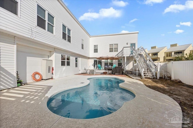 view of swimming pool featuring a deck and a patio area